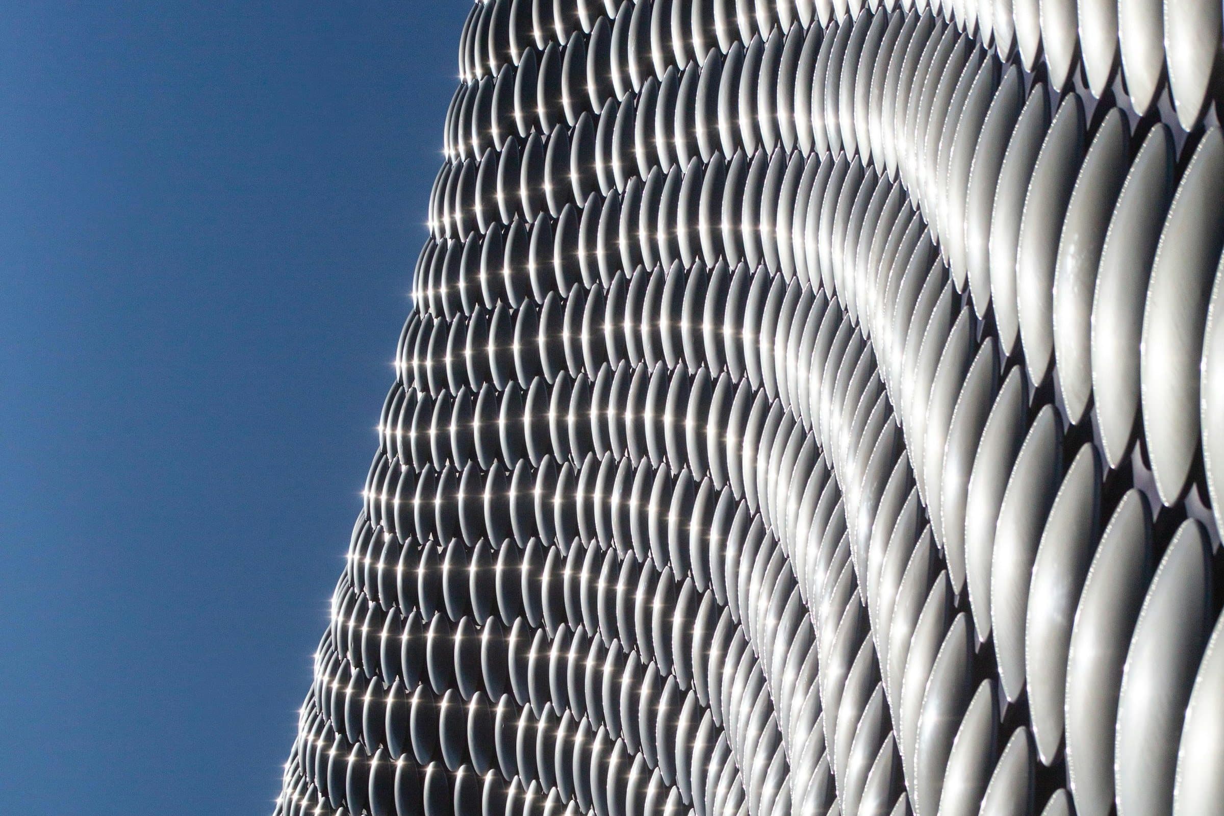 The Selfridges building at the Bullring in Birmingham, its curved facade of aluminium discs against a deep blue sky
